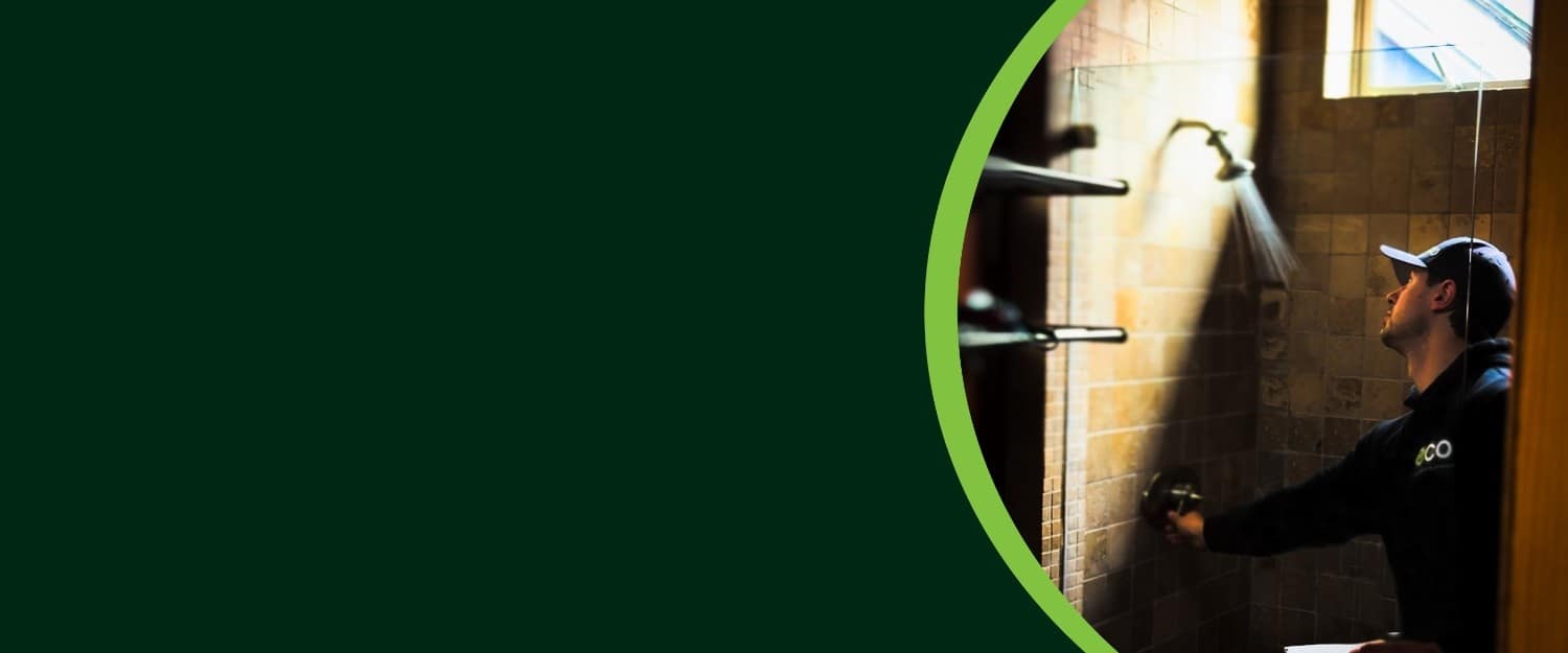 An employee repairing leakage in bathroom ceiling